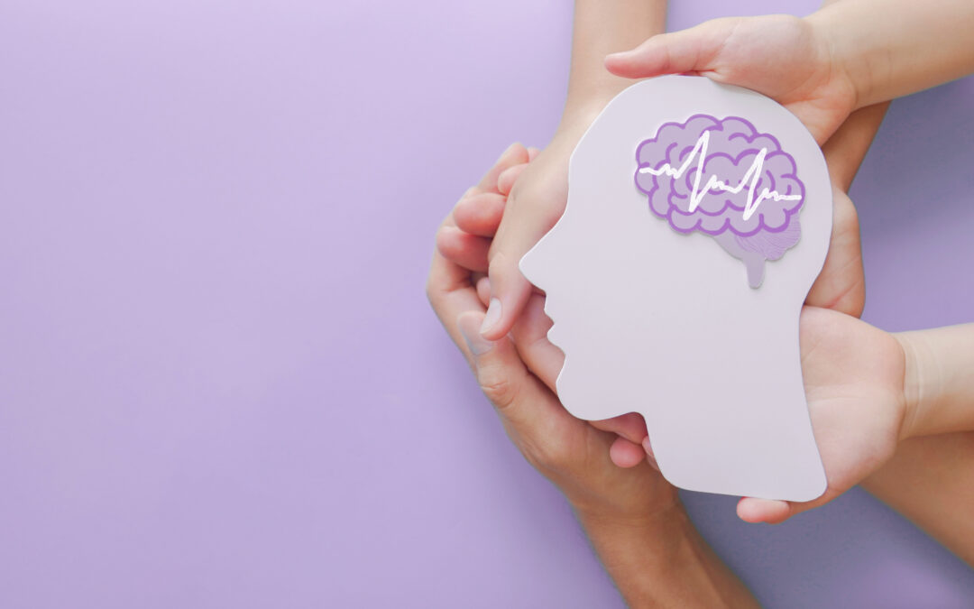 Adult and children holding illustration of brain, promoting ways to maintain a healthy brain